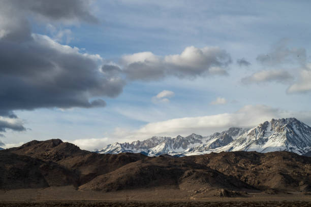 istock brown autumn desert hills snowy mountain ridge 1130538484