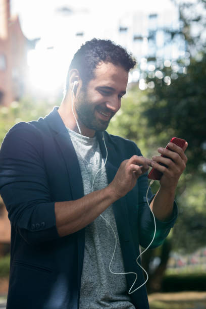 istock Single observing the cell phone in a park 1130538692