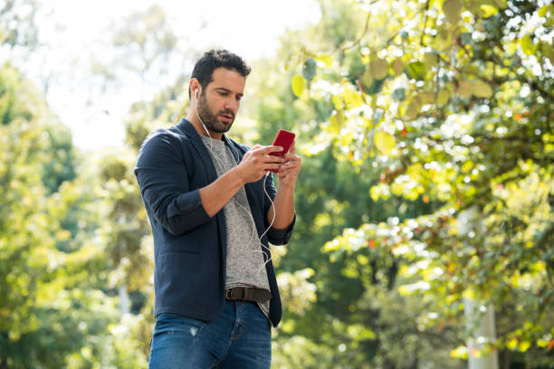 istock Single observing the cell phone in a park 1130539682