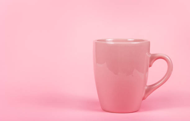 istock Pink mug on pink background. Copy space. Cup of tea on  pink background 1130539741