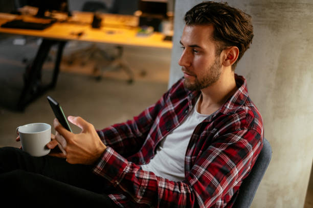 istock Man alone in the office having phone call and coffee 1130539958