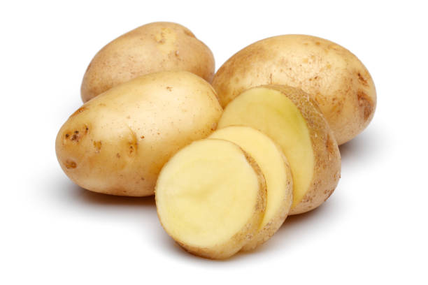 istock Fresh potatoes with slices isolated on white 1130539980