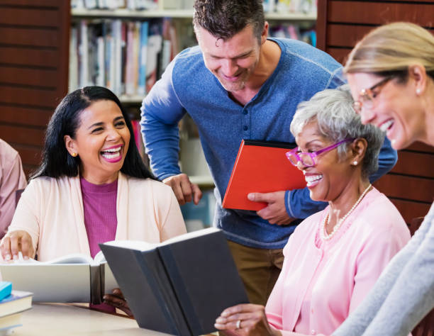 istock Diverse group of adult students conversing in library 1130541550