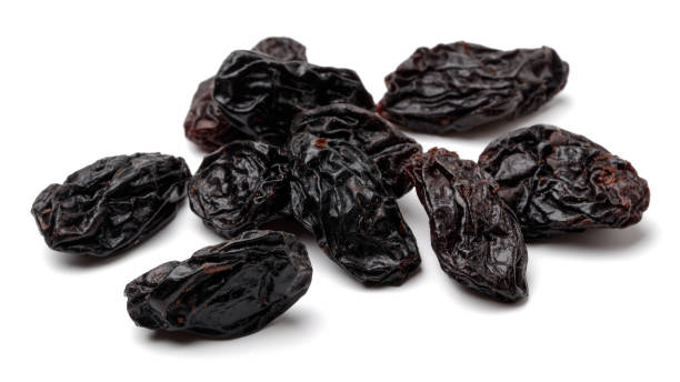 Black raisin isolated on white Black raisin isolated on white background feeding grapes stock pictures, royalty-free photos & images
