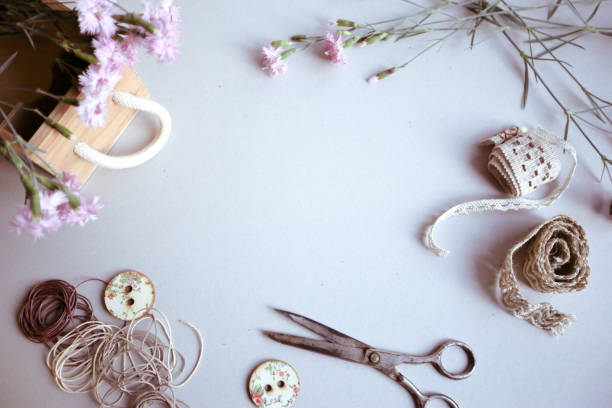 istock Vintage background, hand made. Old scissors, ribbons, wooden buttons, a notebook for text and flowers. 1130542120