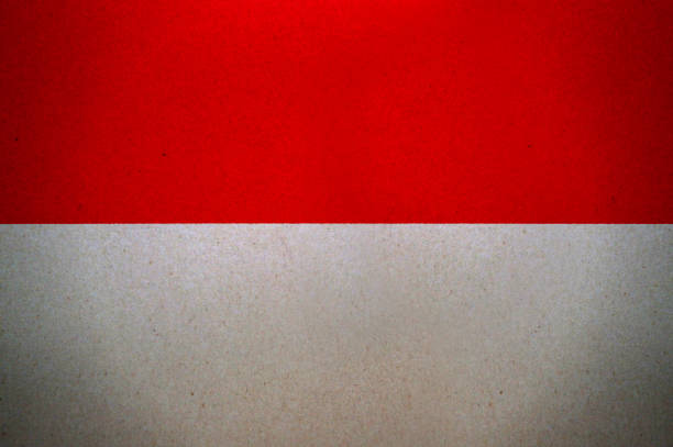 Small paper flag of Indonesia pinned. Isolated on white background. Horizontal orientation. Close up photography. Copy space.