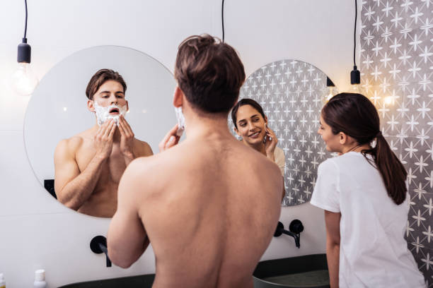 istock Just married couple standing in the bathroom looking into mirrors 1130543226