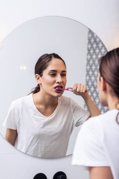 istock Woman brushing teeth in the morning before heading off to work 1130543319