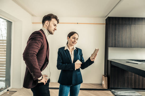 istock Interior designer wearing blue jacket offering some colors for kitchen 1130543352