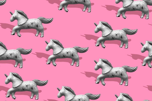 istock Black and white unicorn brooch seamless pattern on pastel pink background. 1130543791