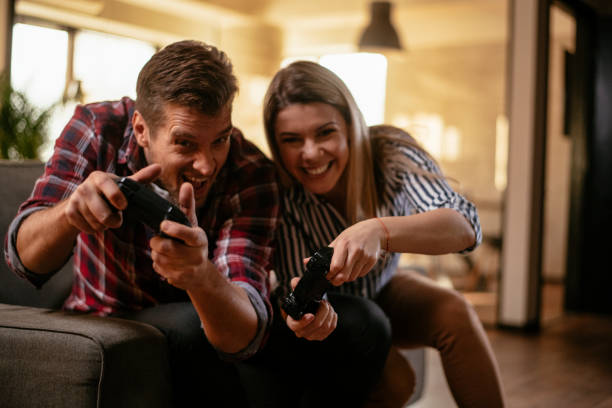 istock Couple having fun playing video games 1130543930