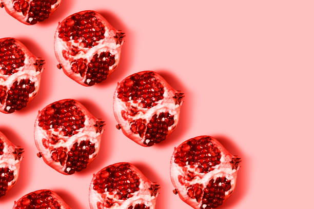 Pomegranate colorful pattern on a pastel pink background.