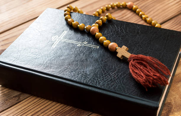 istock Holy Bible with rosary beads on the wooden table. 1130544908