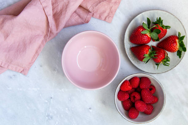 istock Fresh berries in bowl on marble background 1130545051
