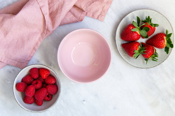 istock Fresh berries in bowl on marble background 1130545086