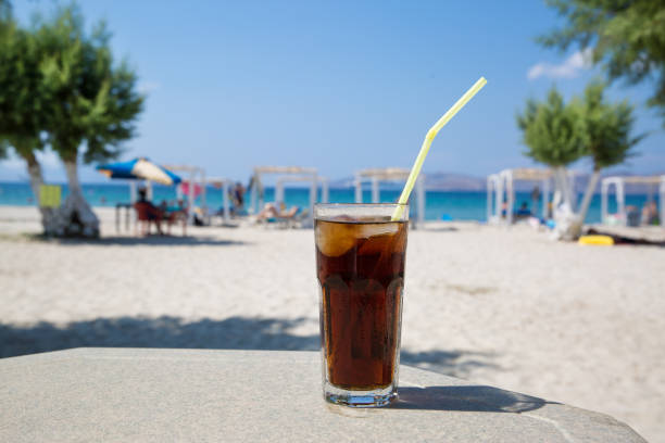 Close-up of summer cocktail on the beautiful blue water background during the sunlight