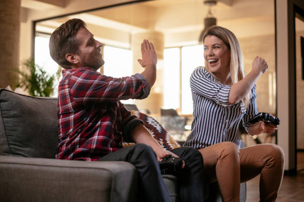 istock Beautiful couple playing video games on console 1130546820