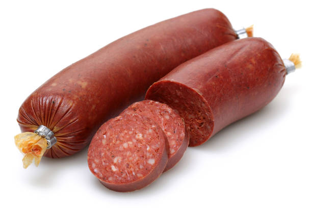 Sliced Turkish sausages isolated Sliced Turkish sausages isolated on white background turkish sausage stock pictures, royalty-free photos & images