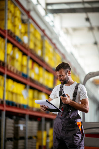istock Factory worker in warehouse with walkie talkie 1130547861