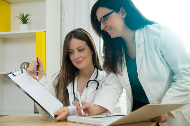 istock Two beautiful female doctors consulting 1130547909