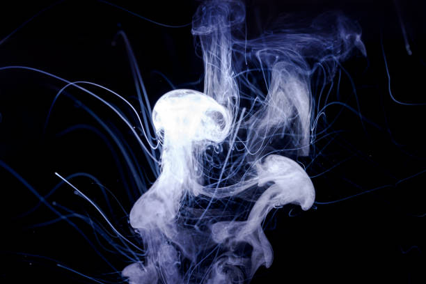 istock Vape smoke clouds isolated on black background. Hot vape liquid splash in vape coil. Nice aromatic cloud. Low light photo. Underexposed photo in a low key style. 1130548043