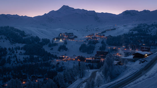 La Plagne ski resort in French Savoy Alps at twilight in winter.