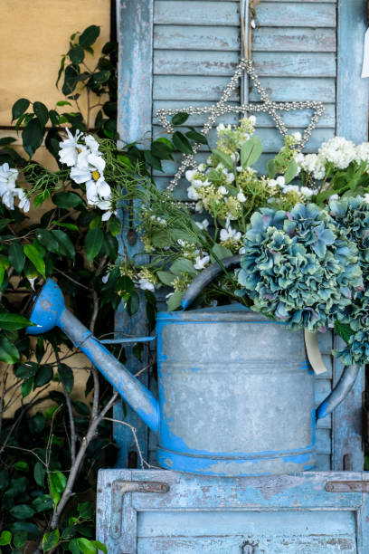 istock Vintage watering can with flowers around 1130549316
