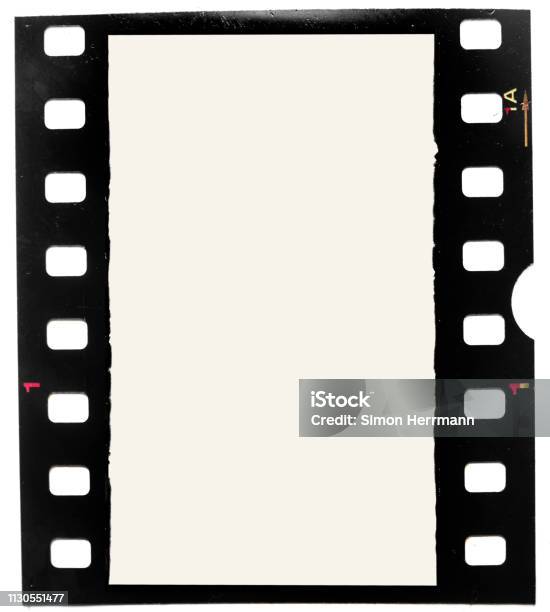 Real Macro Photo Of Grungy Looking 35mm Filmstrip Or Film Frame On White Background Stock Photo - Download Image Now