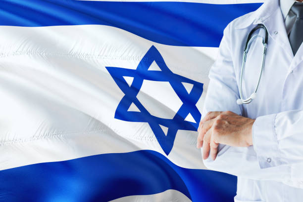Israeli Doctor standing with stethoscope on Israel flag background. National healthcare system concept, medical theme. médico israelí permanente con estetoscopio sobre fondo de bandera de israel. concepto de sistema nacional de salud, tema médico. médico israelí permanente con estetoscopio sobre fondo de bandera de israel. concepto de sistema nacional de salud, tema m