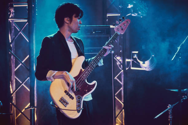 A rock band plays a live performance in a small club in Tokyo, Japan.