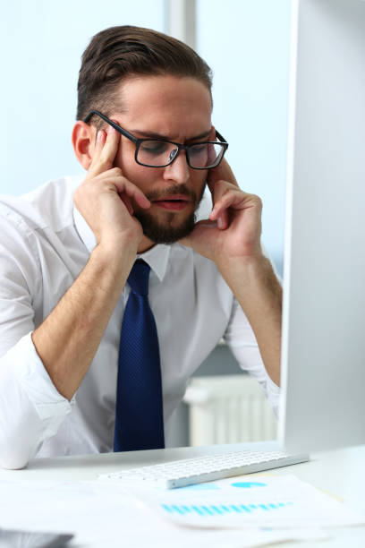 istock Tired clerk at laptop pc workplace wearing glasses 1130554523