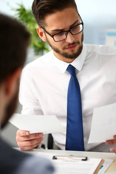 istock Group of businessmen with financial graph in arm solve and discuss problem 1130554588
