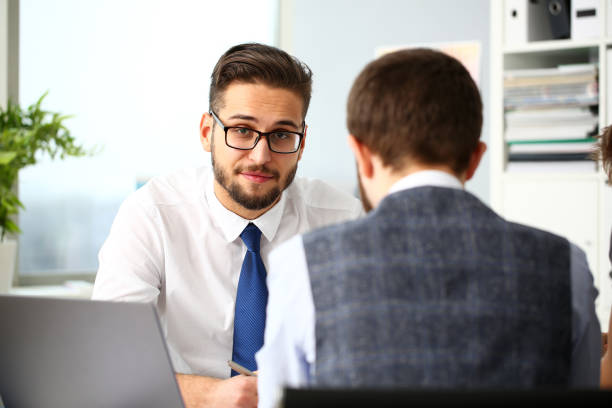 istock Two smiling clerk businessmen deliberate on problem 1130554597