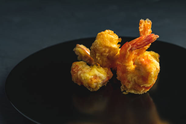 istock Shrimps tempura in black plate on dark concrete surface 1130555533