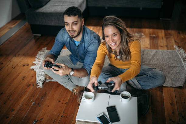 istock Smiling couple playing video games 1130559530
