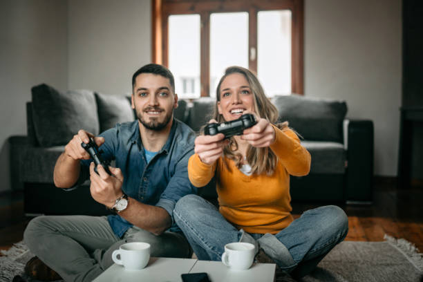 istock Smiling couple playing video games 1130559535