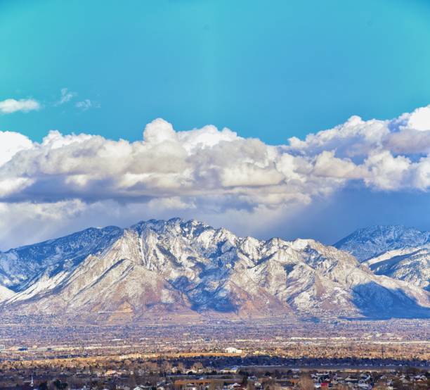 istock Winter Panoramic view of Snow capped Wasatch Front Rocky Mountains, Great Salt Lake Valley and Cloudscape. Utah, USA. 1130559607