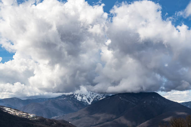 istock The snow capped mountains are covered with thick clouds 1130562712