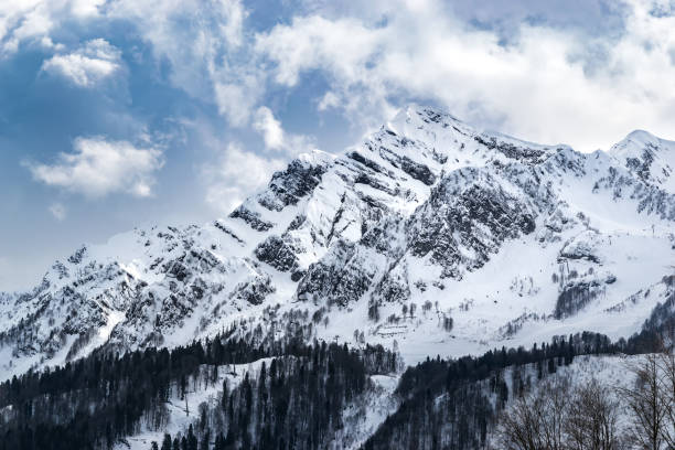 istock The snow capped mountains are covered with thick clouds 1130562720