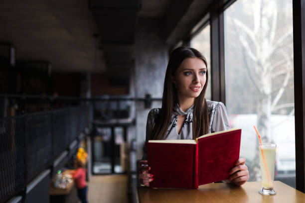 istock Beautiful business woman in cafe holding notebook 1130563034