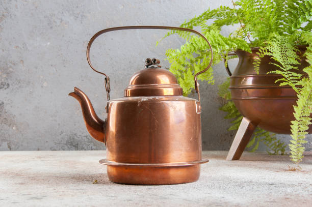 istock Vintage copper kettle on concrete background. 1130563080