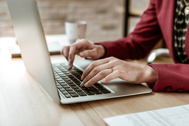 istock Tidy fit businesswoman in red strong jacket using laptop for work 1130564258