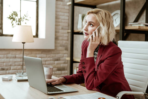 istock Unpleasant short-haired businesswoman rolling her eyes during conversation 1130564285
