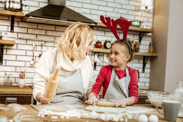 istock Amused short-haired woman looking on happy daughter 1130564542