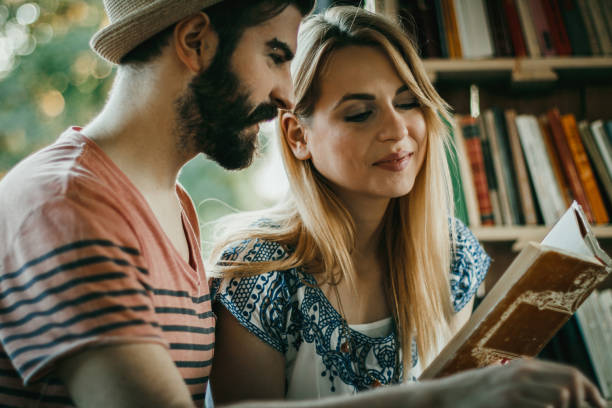 istock Two people studying and reading together in the outdoors public library 1130565207
