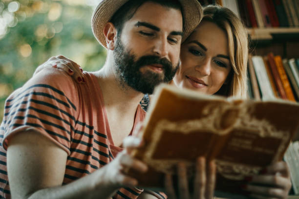istock Two people studying and reading together in the outdoors public library 1130565244