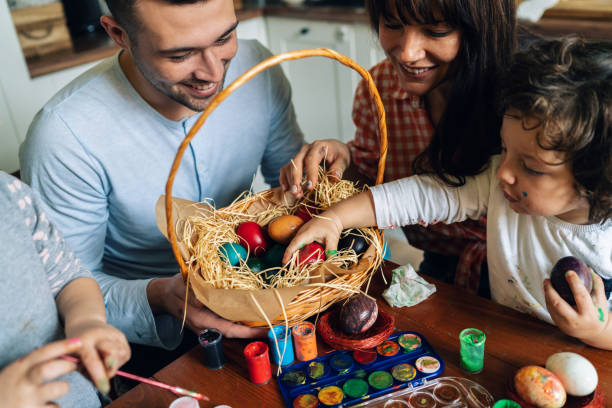 istock Happy family painting Easter eggs 1130566628