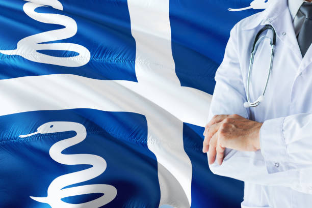 Doctor standing with stethoscope on Martinique flag background. National healthcare system concept, medical theme. el doctor de pie con estetoscopio sobre fondo de bandera de martinica. concepto de sistema nacional de salud, tema médico. el doctor de pie con estetoscopio sobre fondo de bandera de martinica. concepto de sistema nacional de salud, tema médico. médico