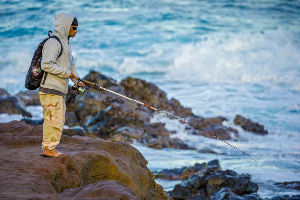 Island of Maui in Hawaii on January 05, 2013: Fishing off Hookipa Beach on Maui