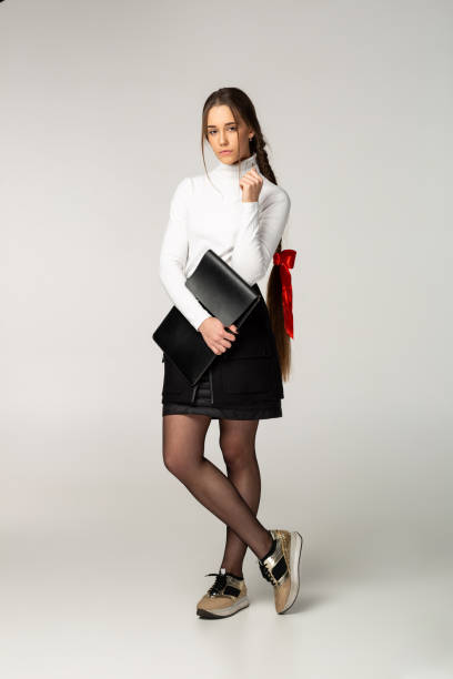 istock Young business lady in white golf, posing in the studio 1130568097